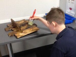 Sandon pupil making wooden shelf