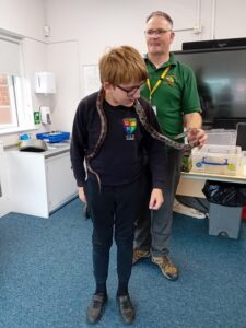 child with snake around his neck
